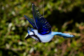 glass bluejay figurine with ashes