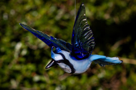 glass bluejay figurine with ashes