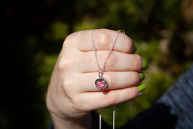 Dainty Silver Heart Pendant, with a mix of pink crushed opal, held by model. Dainty Necklace, Small Necklace, Tiny Necklace, Silver Necklace for Ash, Necklace for Ash, Simple Necklace for Ash, Cremation Jewelry