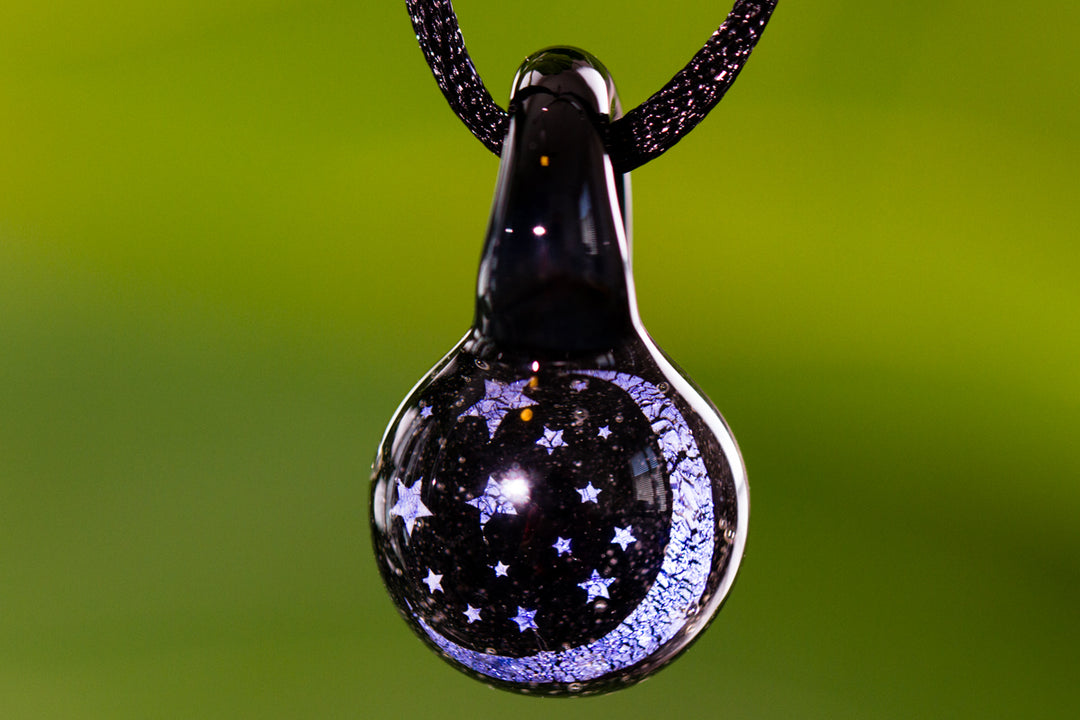Glass Moon and Stars hologram pendant infused with cremation ash hanging from an adjustable cord