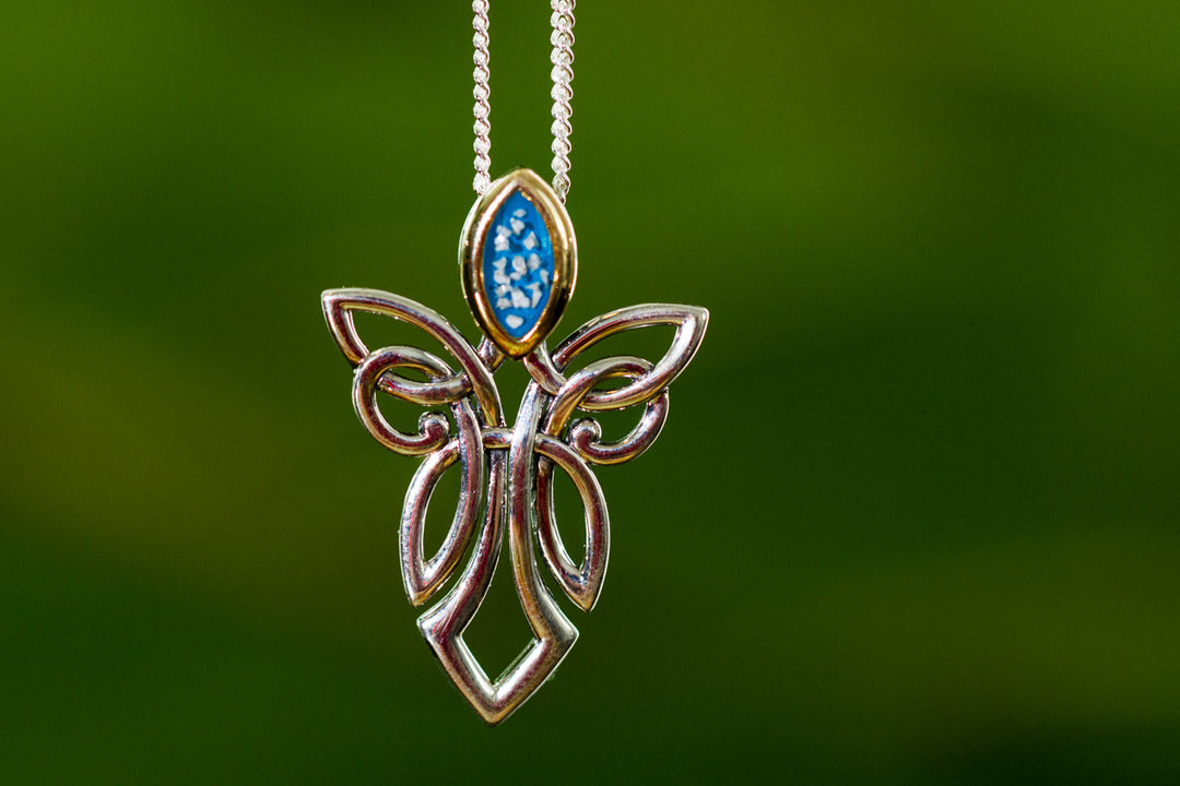 Sterling silver guardian angel pendant with a gold head and blue marbled gemstone, hanging from a silver chain