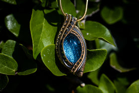 cremation jewelry with blue glass on leaves