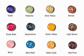Grid of ash infused resin beads in bright colors used for charms and pendants.