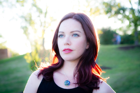 a women wearing a cremation pendant in blue