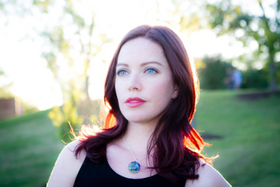 a women wearing a cremation pendant in blue