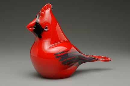 Side profile of glossy red glass cardinal cremation keepsake.