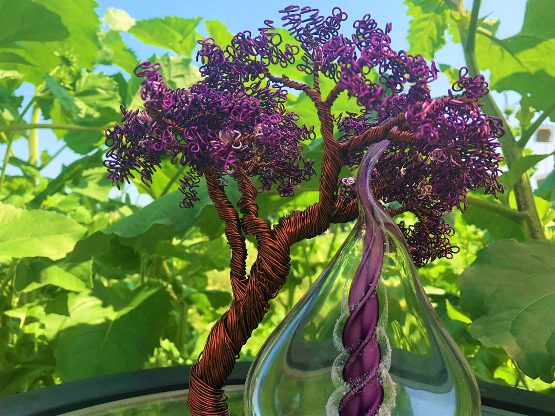 Close up of Wire Wrapped Tree of Life with Memorial Flame showing purple glass flame entwined with copper wire tree