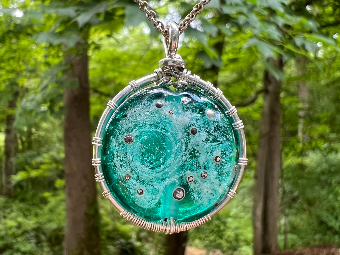 Moon and Stars Tree of Life pendant in sterling silver with a starry night glass bead and cremains visible on the back