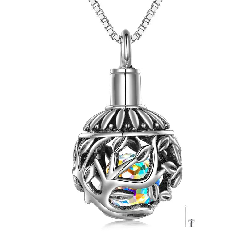 Shiny silver cremation pendant featuring a tree of life design and multicolored crystals inside on a white background