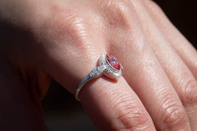 The photo is of our Bedazzled Cat Eye Cremation Ring on a model's hand. It is a zircon studded, sterling silver ring with a cabochon comprised of crushed opal and cremation ash. The stone in this image is red and magenta. Sterling Silver Ring, Sterling Silver Cremation Jewelry, Jewelry for Ash, Cubic Zirconia Ring, Classic Jewelry Style Ring, Ring for Cremation Ash