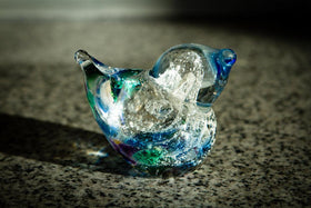 bird in the hand memorial with infused ash in glass