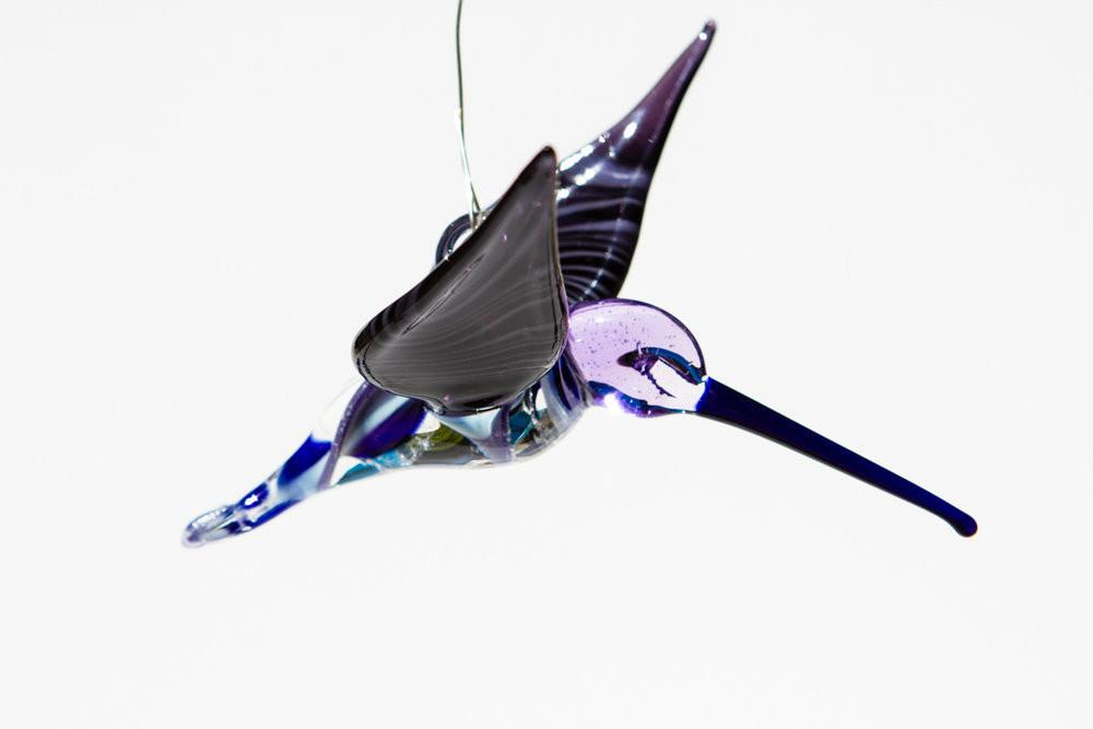 Blue and purple glass hummingbird ornament infused with cremation ashes, swirled through the body with a glass hanging hook.
