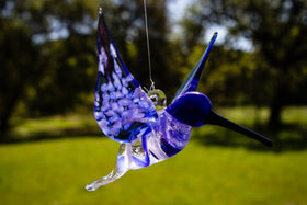 blue glass hummingbird with cremation ash