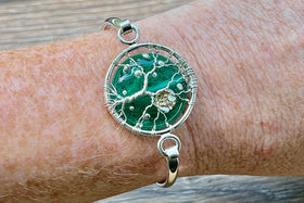 bracelet with cremation ash  on wrist in teal