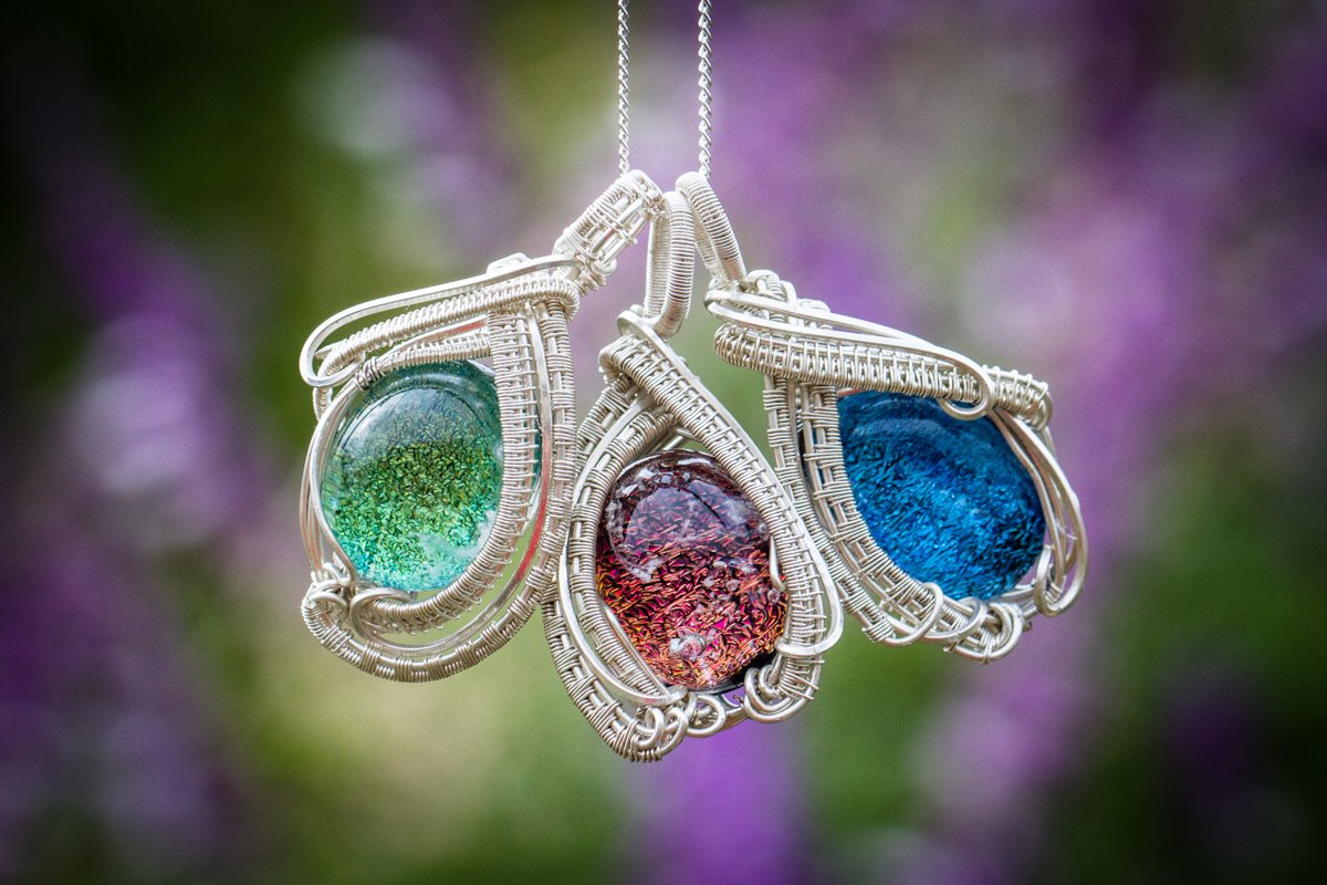 https://www.spiritpieces.com/cdn/shop/products/brooklyn-sterling-silver-wire-wrapped-dichroic-glass-pendant-with-cremation-ash.jpg?v=1590950231