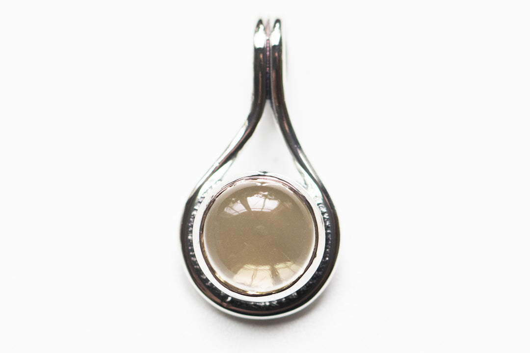 Sterling silver teardrop memorial pendant with a warm tan round stone centerpiece and back ash space