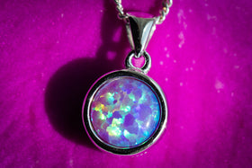 cremation jewelry with with opal and cremation ash purple