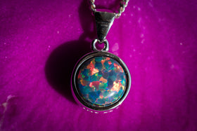 cremation jewelry with with opal and cremation ash dark rainbow