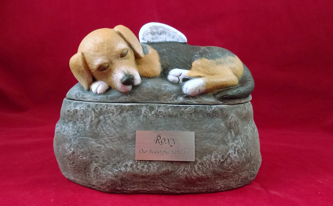 Custom painted ceramic short-haired dog urn two piece design with a sleeping dog on a rocky base and engraved name plate.