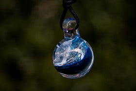 dichroic ball with cremation ash in blue