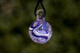 dichroic ball with cremation ash in purple