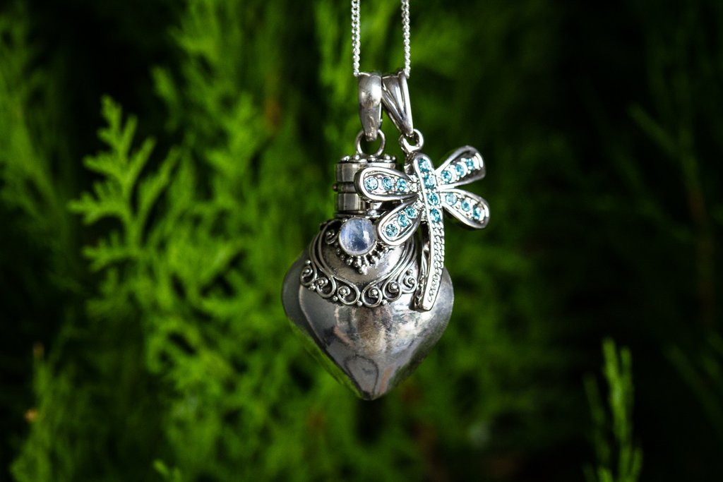 Sterling silver heart keepsake urn pendant with a jeweled dragonfly accent and chain.