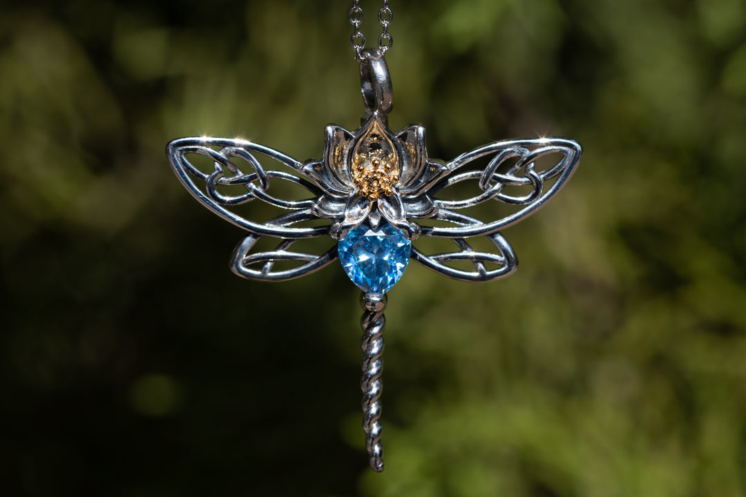Silver dragonfly keepsake pendant with a blue faceted crystal centerpiece on a delicate chain