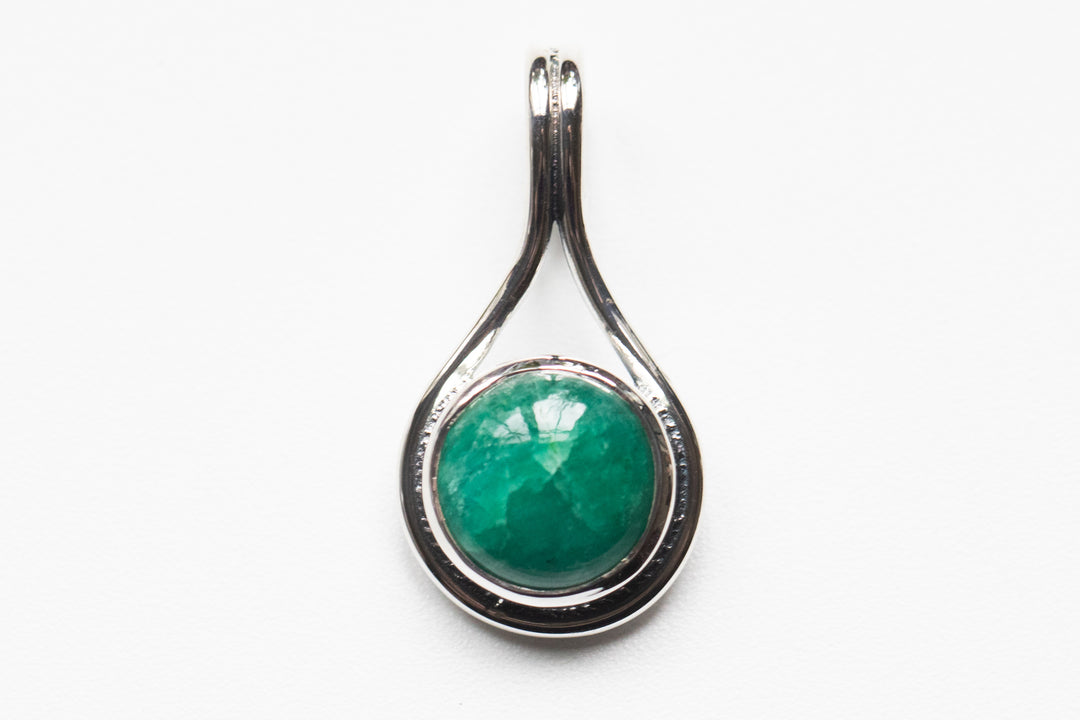 Sterling silver teardrop memorial pendant with a green round stone centerpiece and back ash space