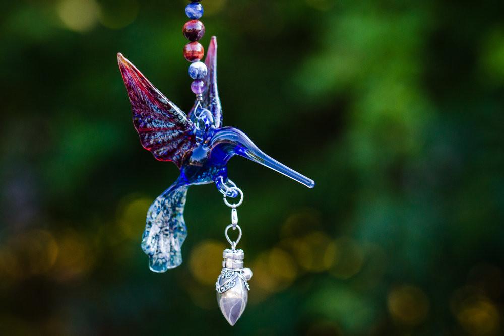 Blue and red glass hummingbird pendant with a crystal butterfly and a silver keepsake urn for ashes, accented by beads