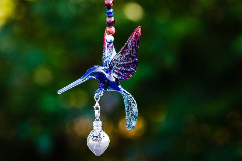 Blue glass hummingbird with tiger's eye and sodalite beads, crystal butterfly, and a removable silver keepsake urn pendant