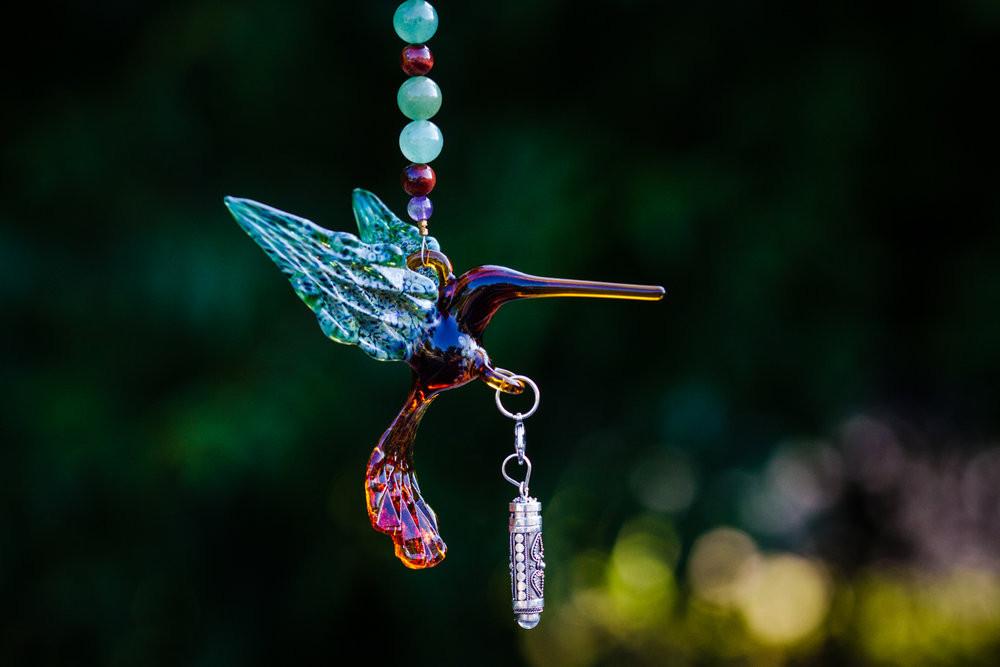 Tan and green glass hummingbird with aventurine and red tree agate beads, crystal butterfly, and a removable silver keepsake urn pendant