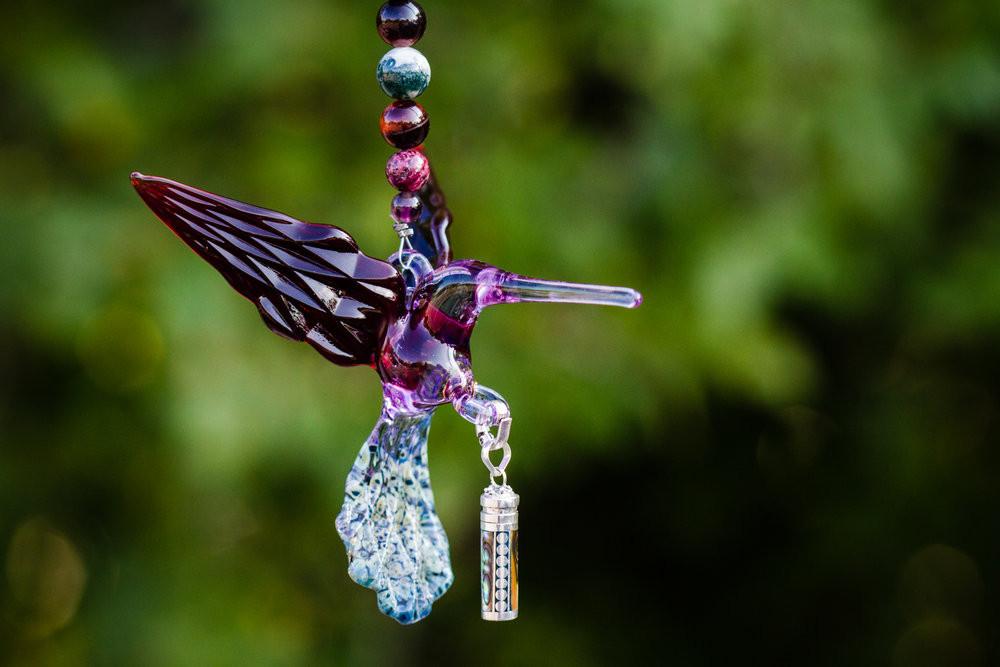 Purple maroon glass hummingbird pendant with beaded strand and detachable keepsake urn for ashes.