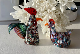 glass hen with ashes next to rooster