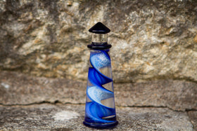 glass lighthouse with ashes