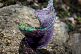 glass sculpture with cremation ash and dichroic glass above in purple