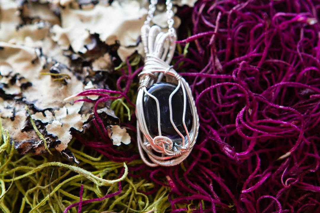 Wire wrapped glass pendant with cremation ash