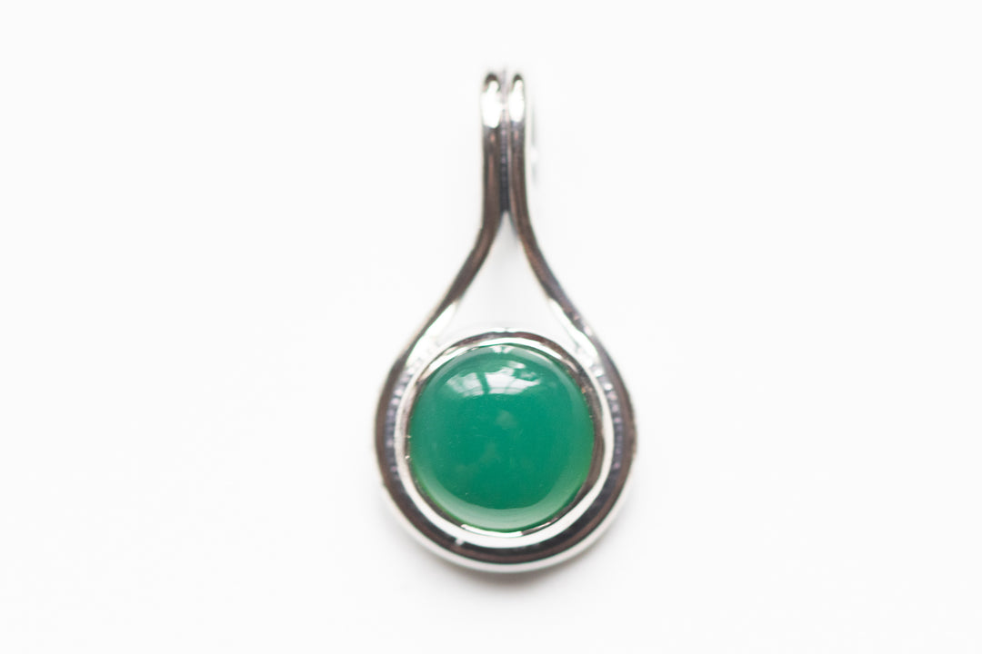Green circular stone in a silver teardrop memorial pendant designed to hold cremation ash