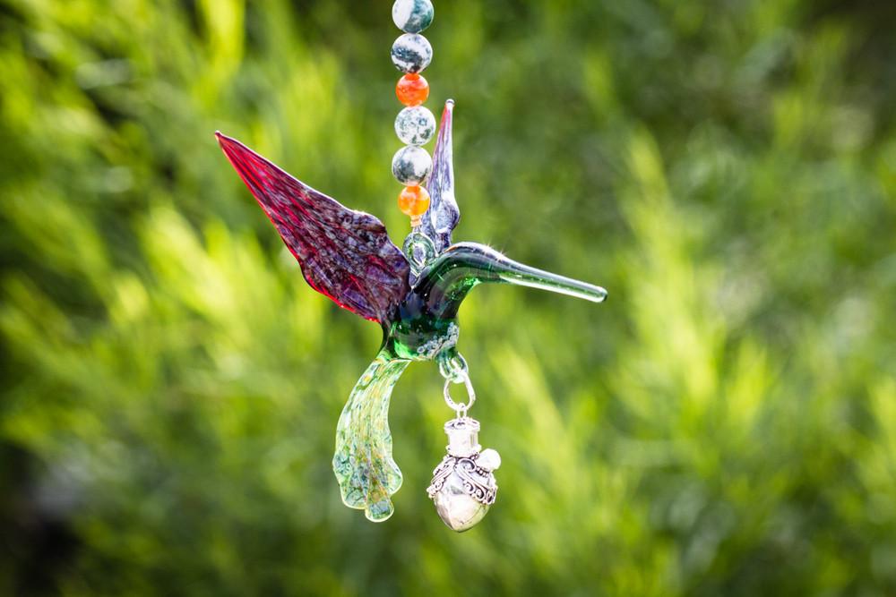 Green and red glass hummingbird ornament with multicolored beads and a crystal butterfly, linked to a silver keepsake urn pendant