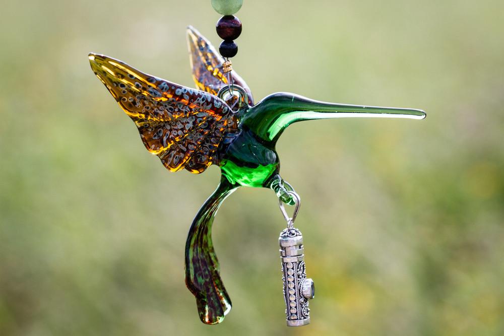 Green and amber glass hummingbird pendant with a silver keepsake urn and crystal butterfly on a beaded strand
