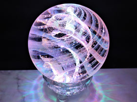 dichroic glass orb with cremation ash made in memory of a loved one.