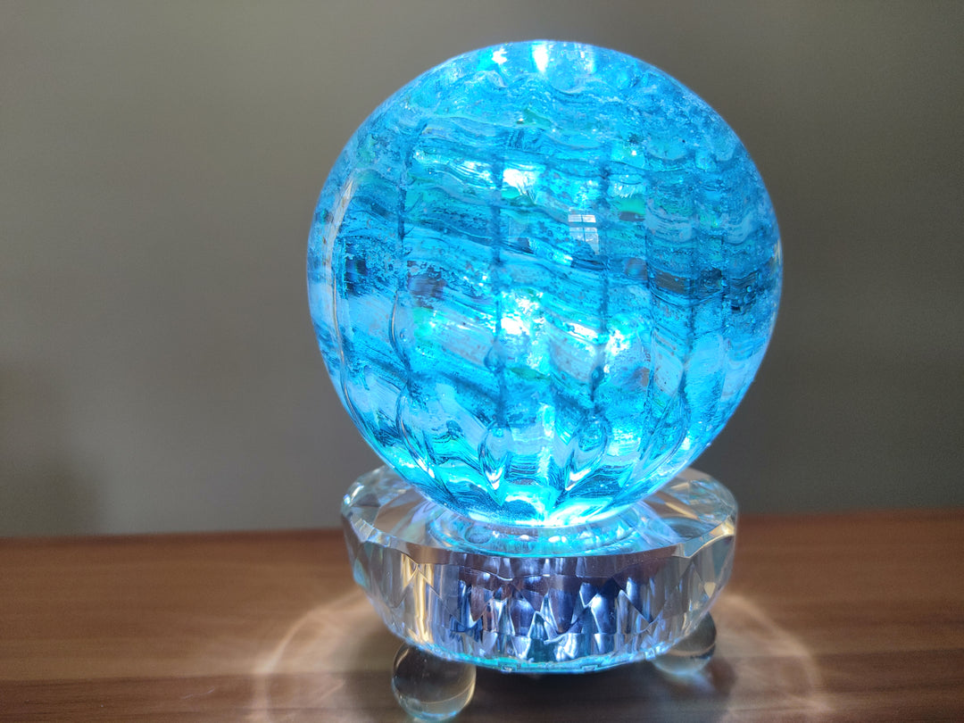 Blue glowing glass orb atop a clear faceted crystal light stand powered by USB.
