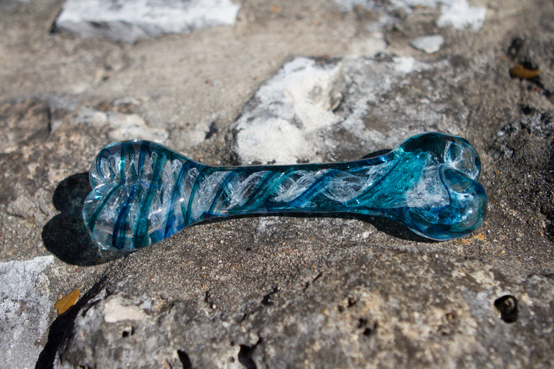 Teal and blue swirl glass dog bone sculpture infused with cremains.
