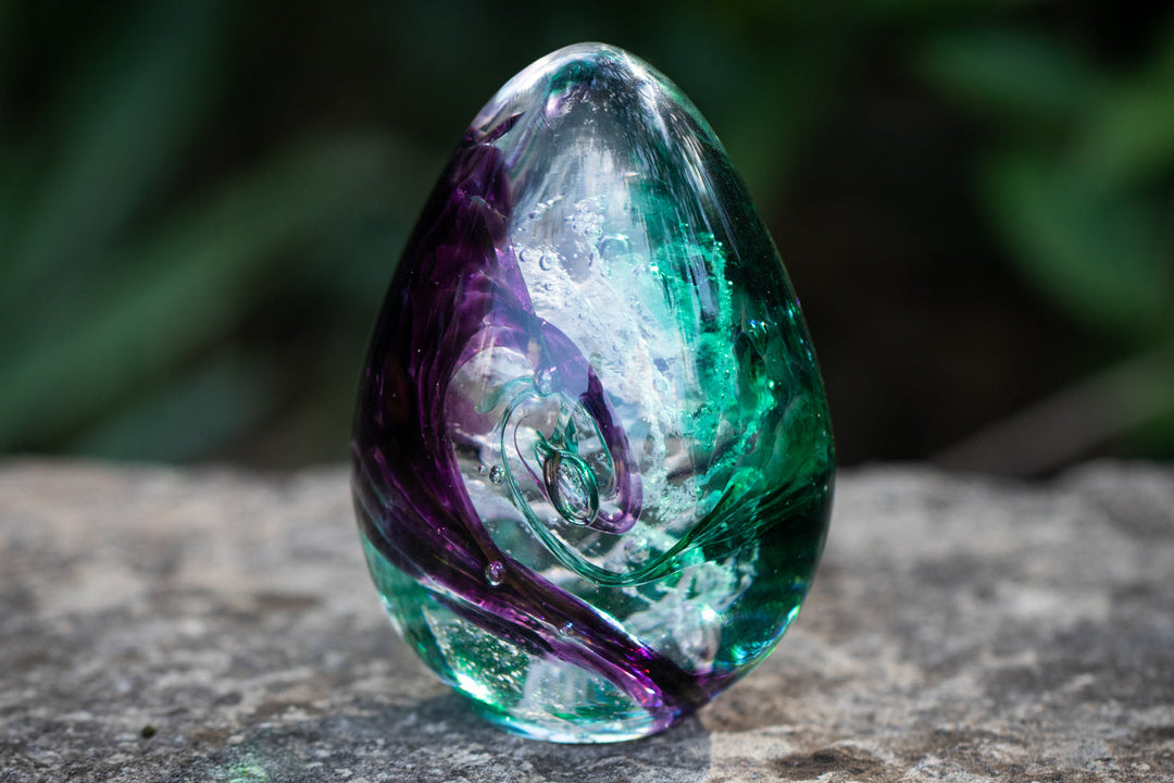 glass egg with cremation ash from pets and people.