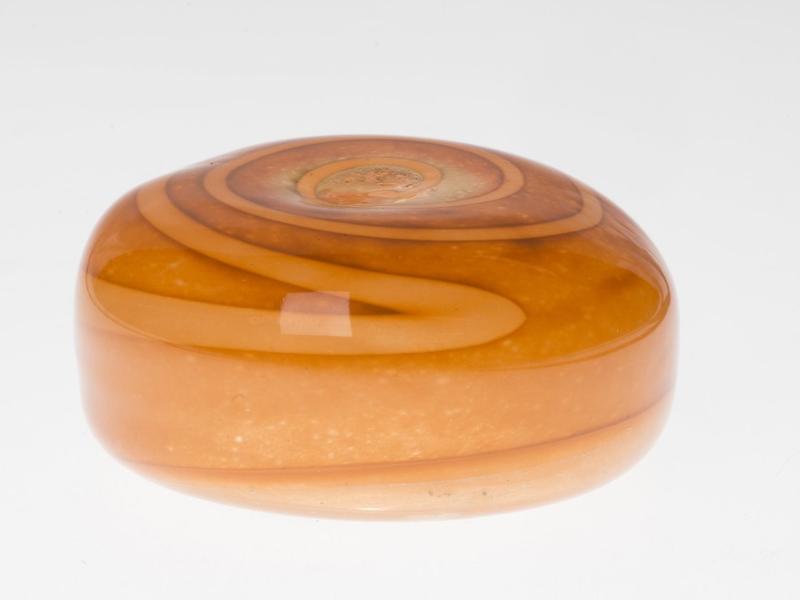Orange tan luminary votive stone with swirled bands and a hollow center for an LED tealight.