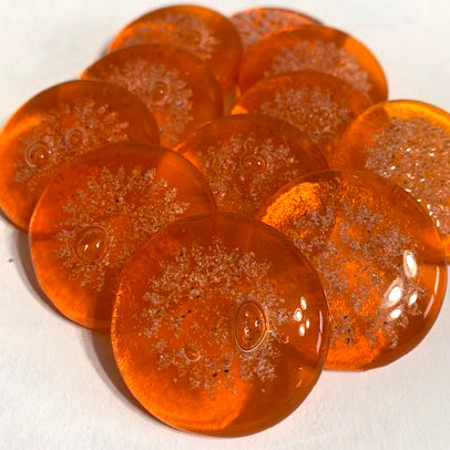 Orange glass cremation ash stones arranged in a cluster from the Sharing Stones Multi-Pack