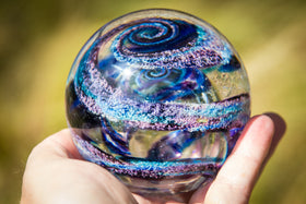 orb with cremation ash blue violet held