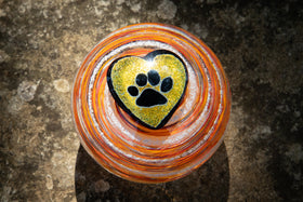 glass orb with cremation ash top orange