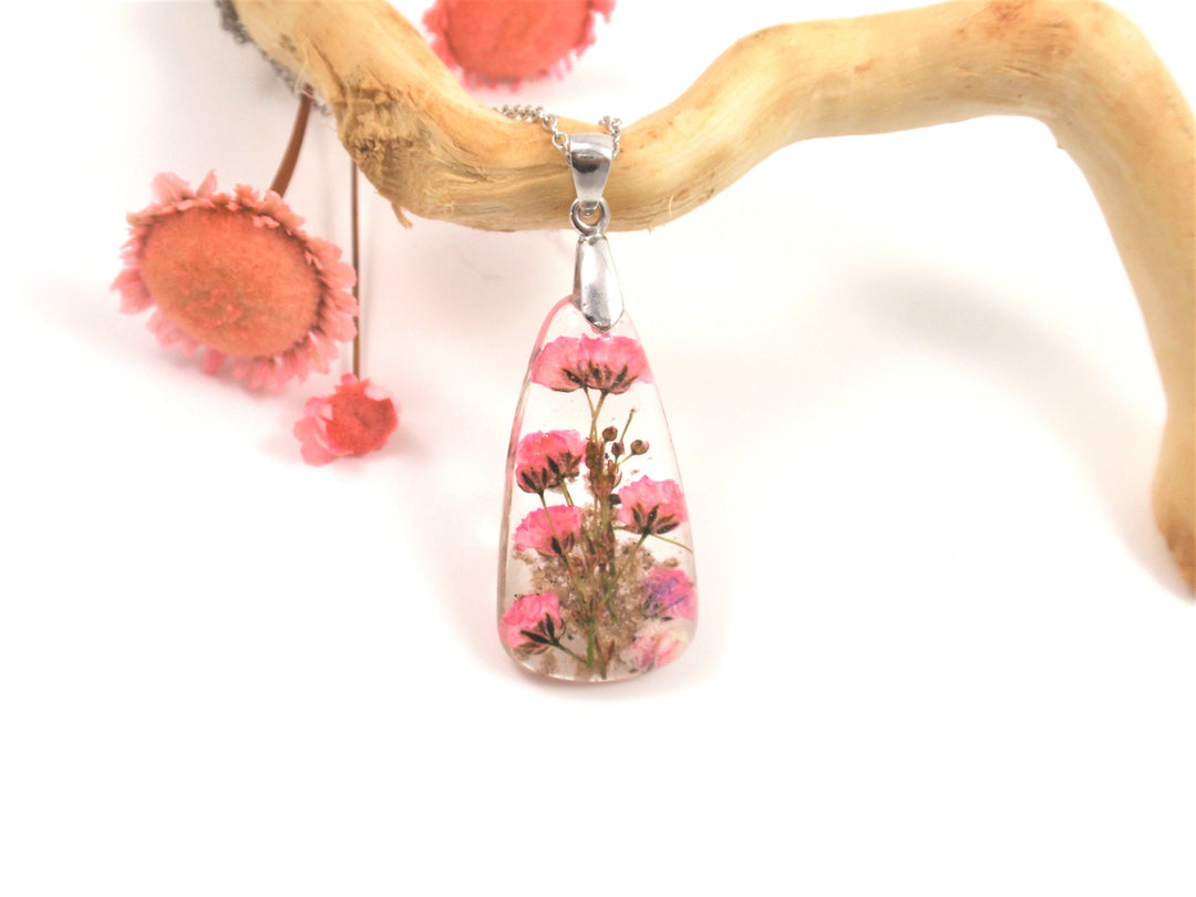 Teardrop resin pendant containing pink baby's breath flowers