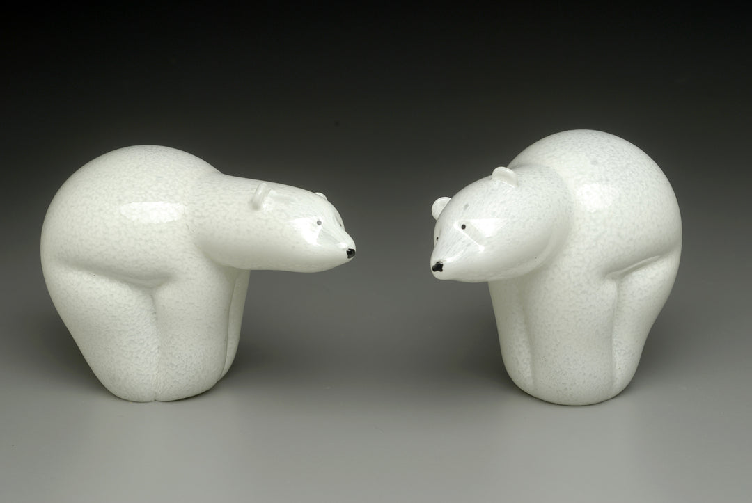 Two white ceramic polar bears facing each other as a cremation ash keepsake sculpture