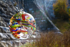 rainbow confetti orb hanging by damn with sunbeam